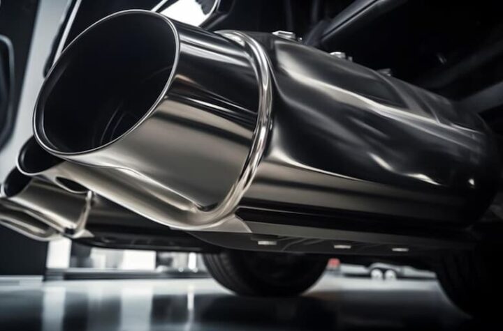 A detailed view of a car's exhaust system showing its metallic structure and emission outlet