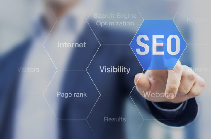 Search Engine Optimization consultant touching SEO Strategy button on whiteboard