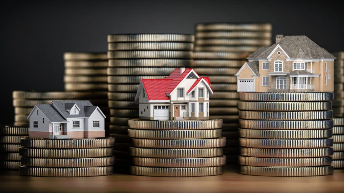 Three toy houses & stack of coins showcasing advertising property tips for maximum profit & renting a flat